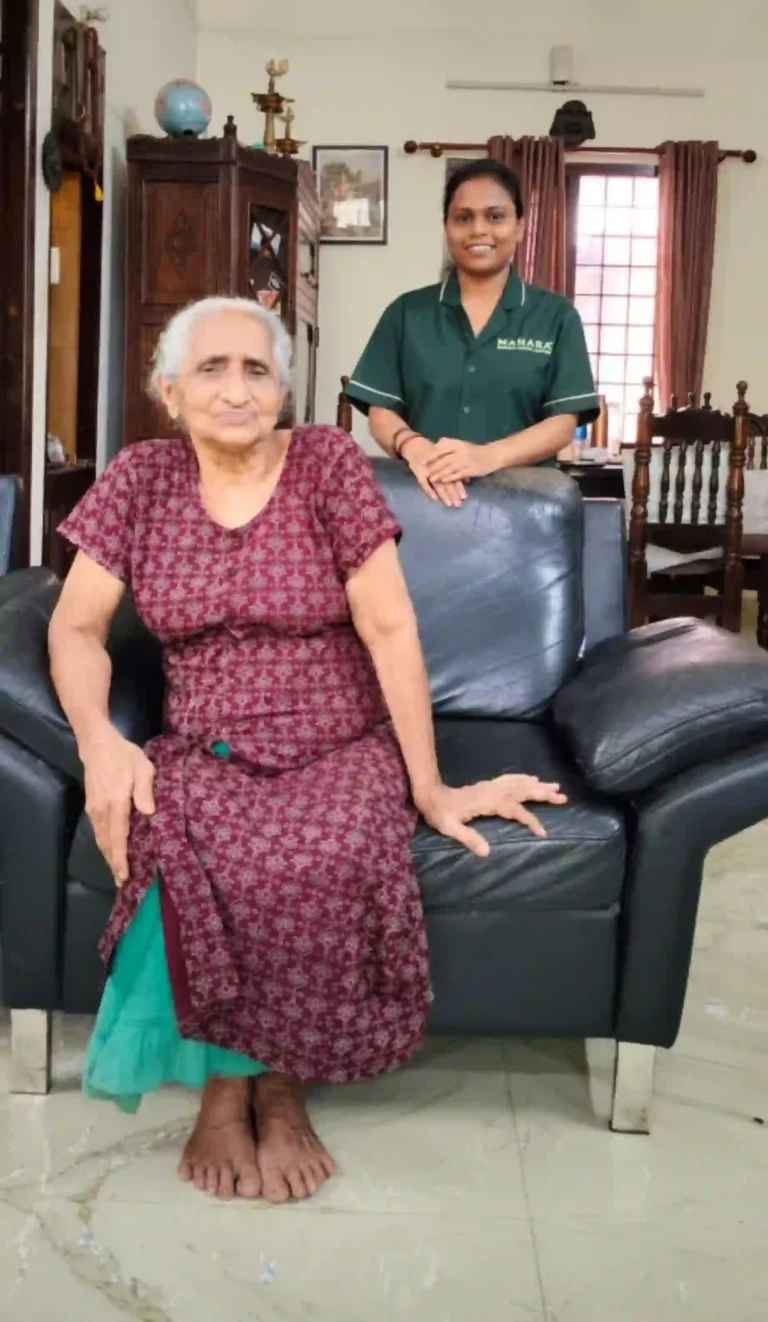 Mahara caregiver standing behind a seated elderly patient