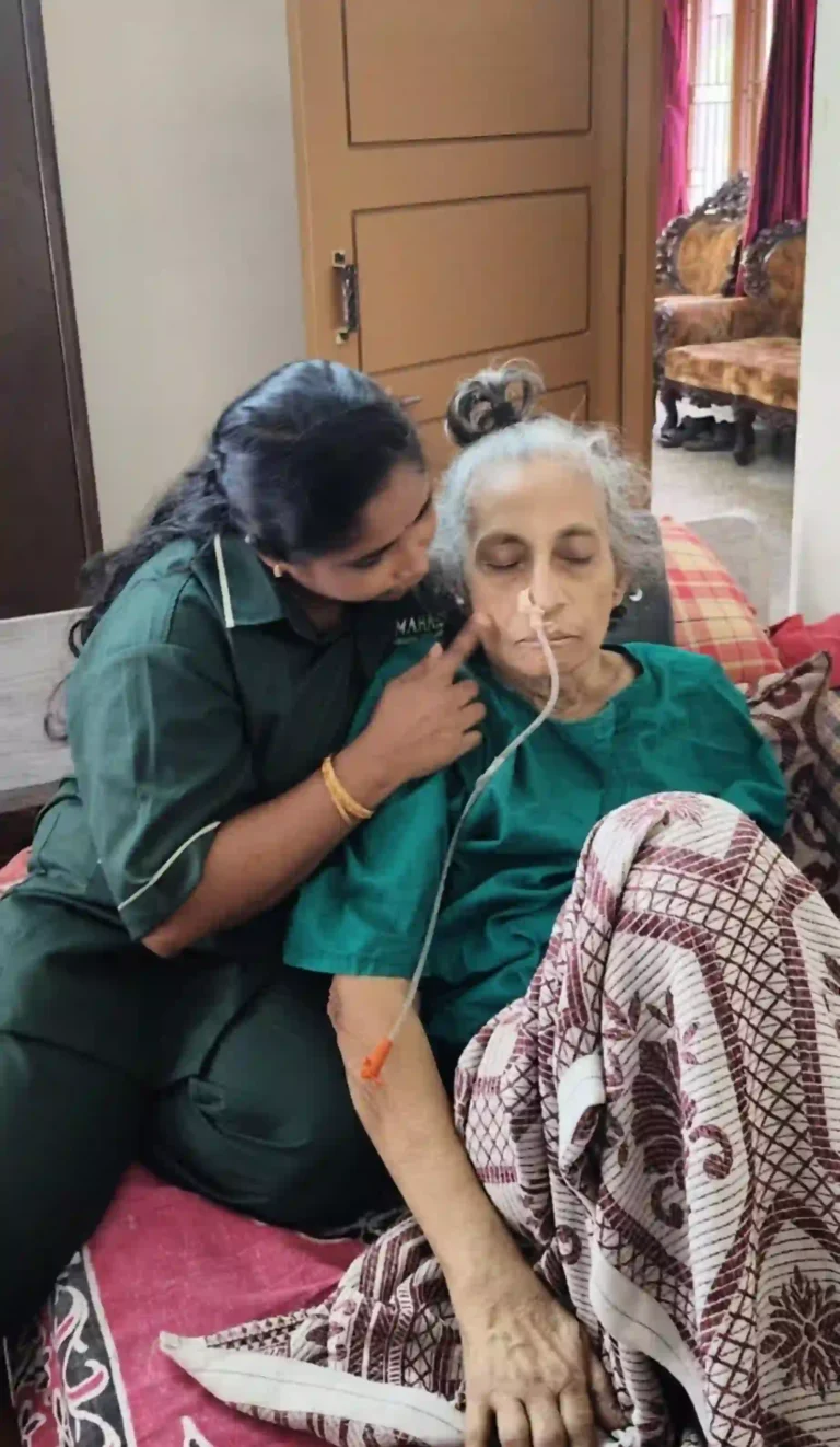 Mahara home nurse caring for a bedridden senior patient with a nasal tube.