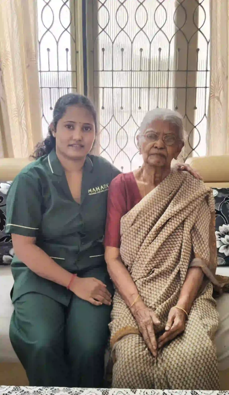 Mahara home nurse seated with senior patient.