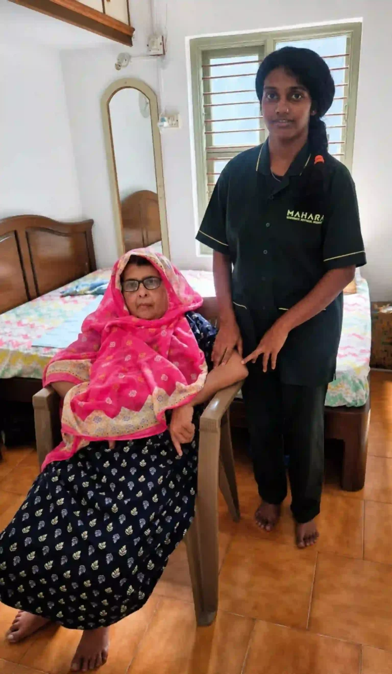Mahara home nurse standing with a senior woman seated on a chair