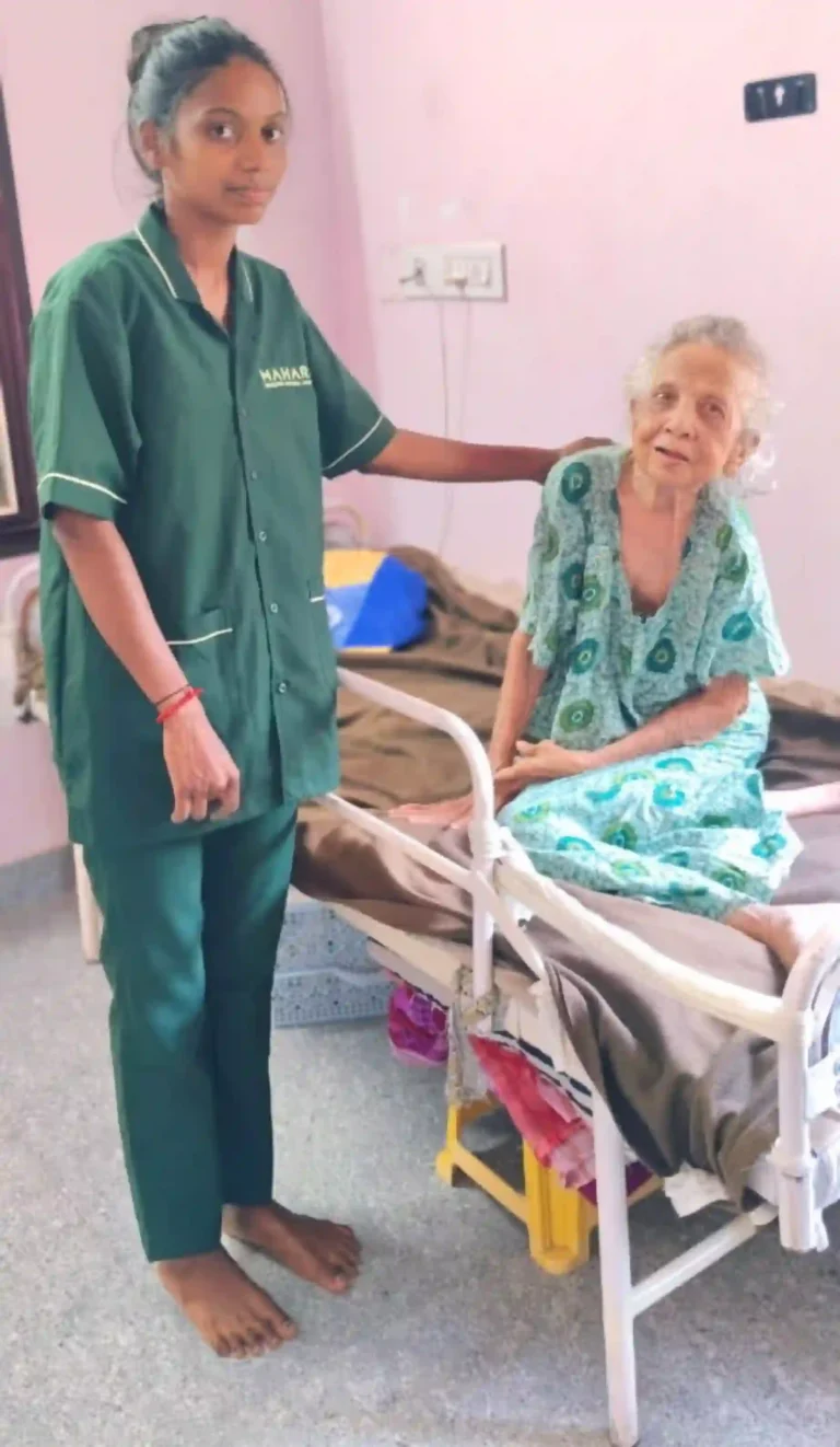 Mahari home nurse standing next to an elderly woman sitting on a medical bed