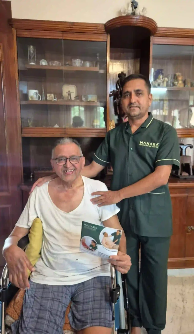 Male Mahara caregiver with senior patient in wheelchair.