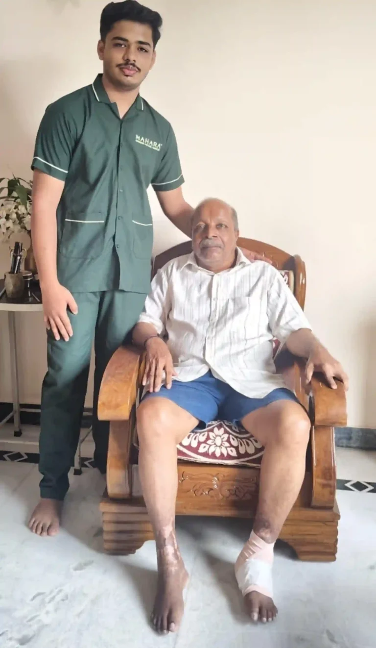 Male Mahara home nurse standing with an elderly male patient